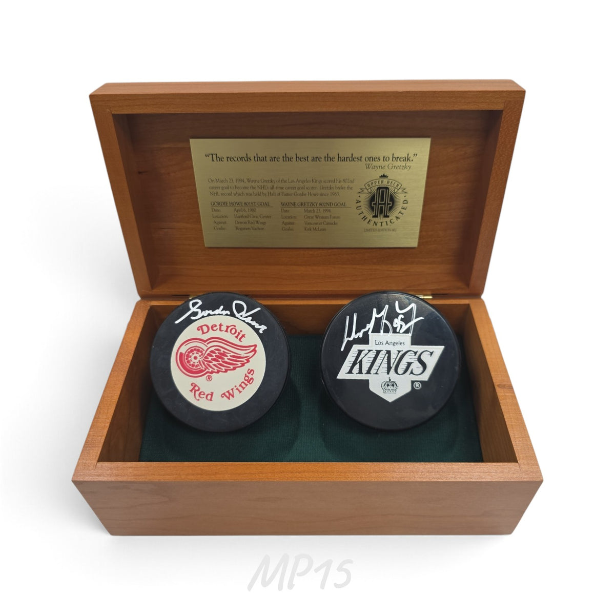 Lake Country Cards autographed Detroit Red Wings and Los Angeles Kings hockey pucks in a wooden display box.
