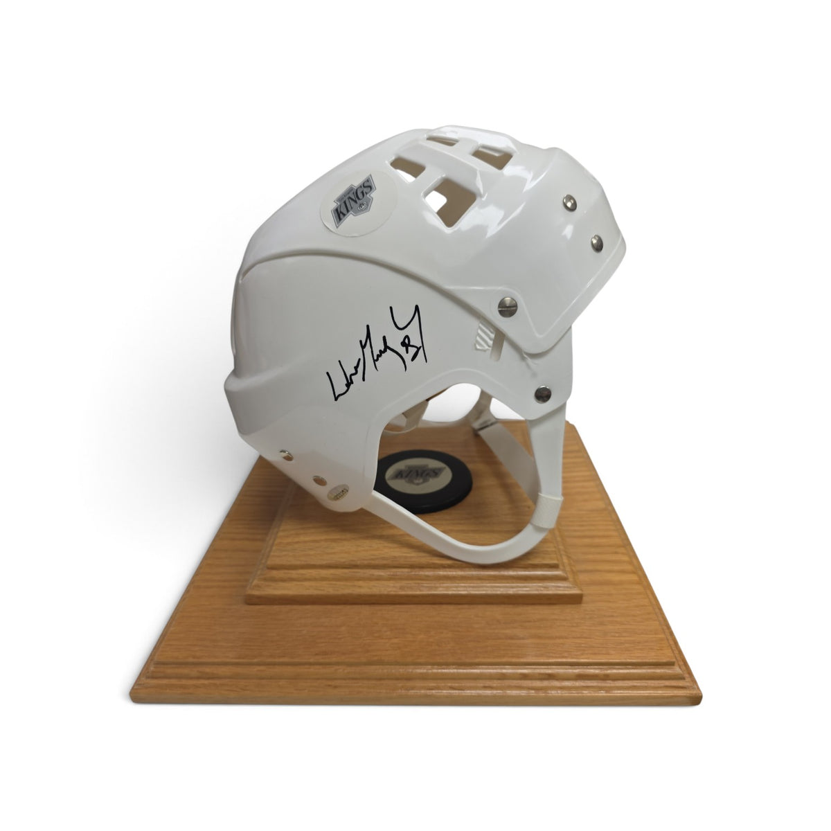 Lake Country Cards autographed white Los Angeles Kings hockey helmet on a polished wooden display base with a puck.